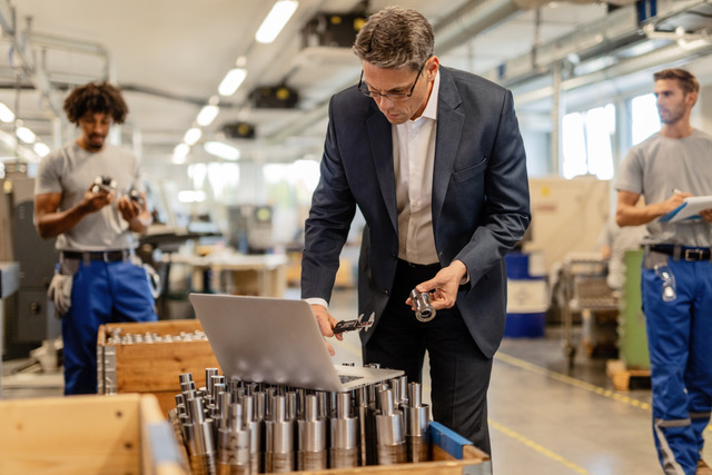 Man working in digitalized factory with lean manufacturing systems